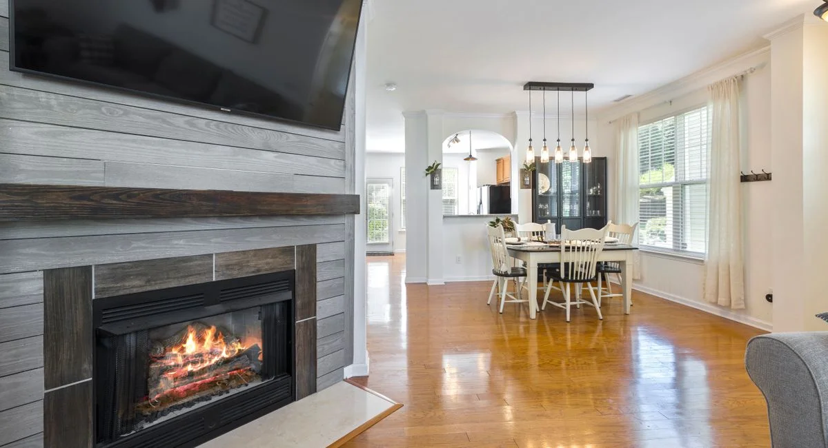 Elegant interior design featuring a cozy fireplace and modern dining area.