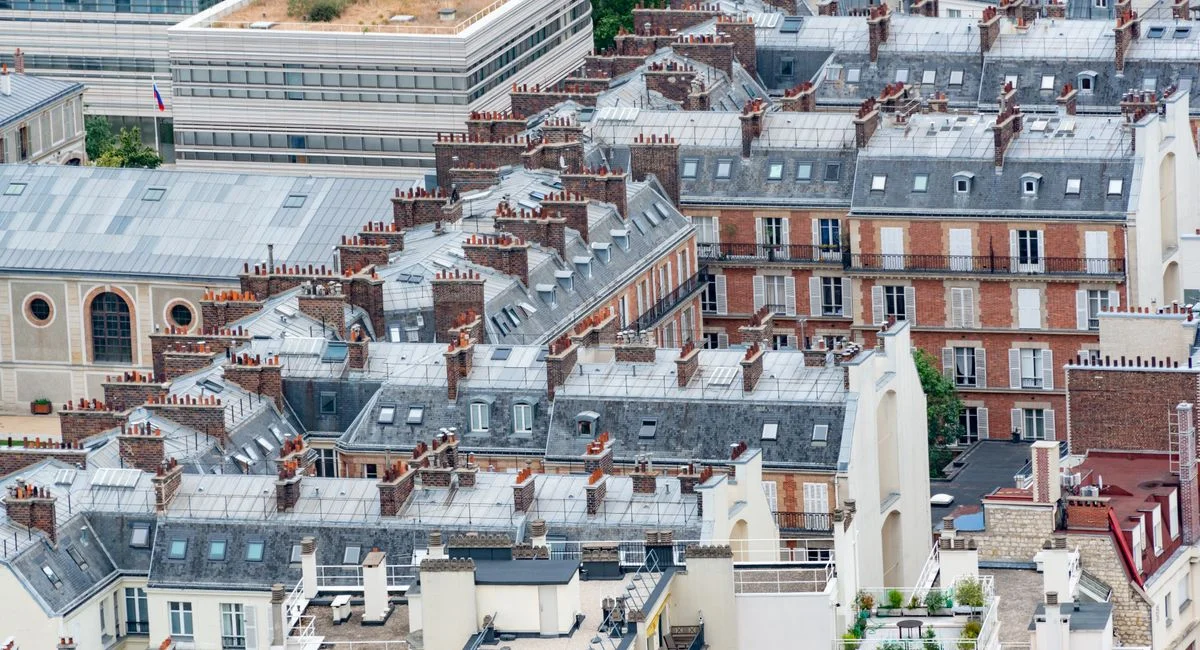 Charming aerial view of traditional Parisian rooftops showcasing classic French architecture.