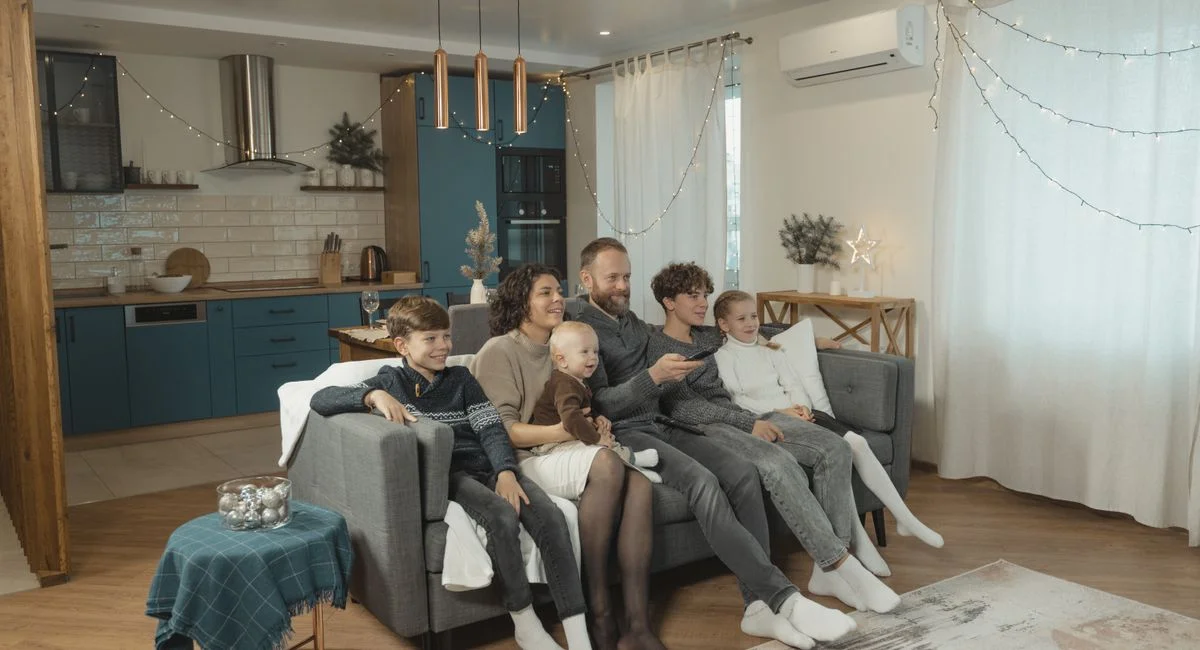 Happy family enjoying quality time together on cozy living room couch.