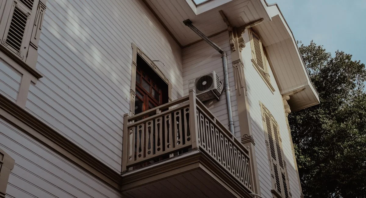 Low angle view of a classic Ottoman-style building facade with balcony in Istanbul, Turkey.