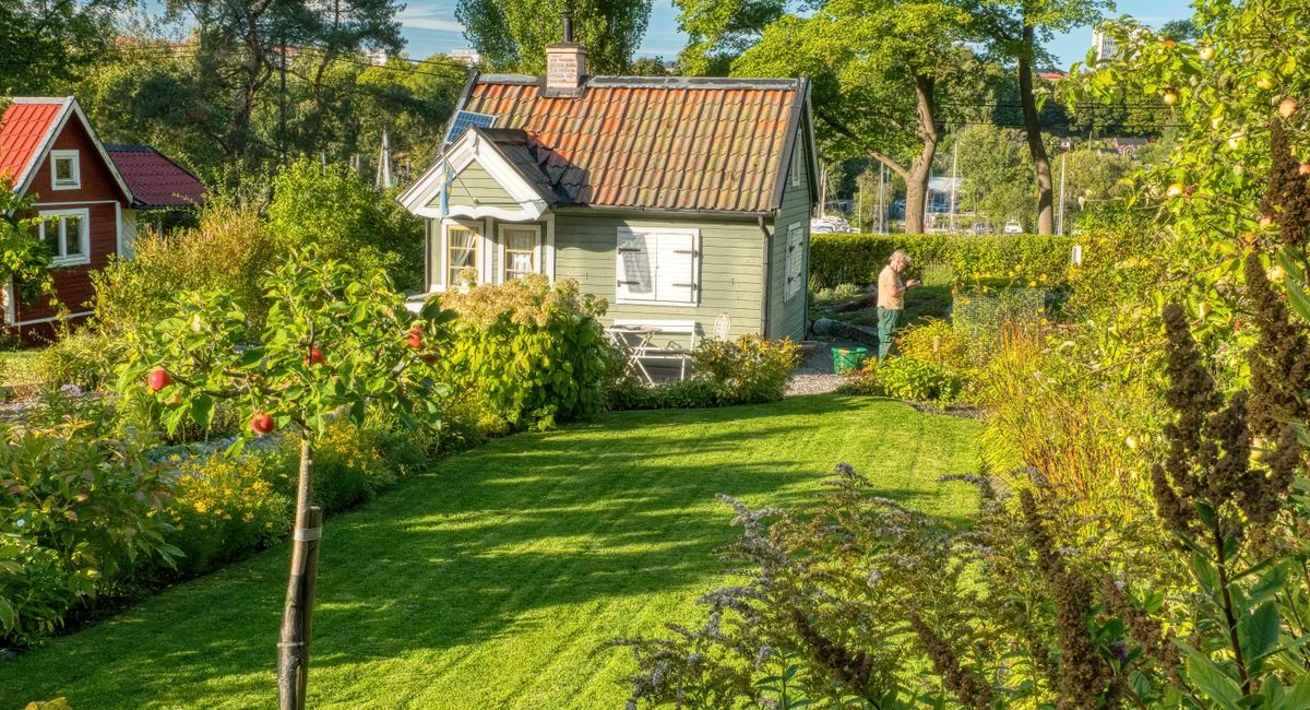 A picturesque summer garden with a quaint cottage in Stockholm, Sweden.