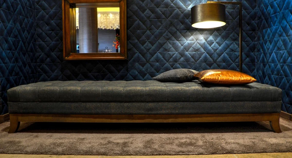 A stylish and modern bedroom featuring a cozy daybed and ambient floor lamp.