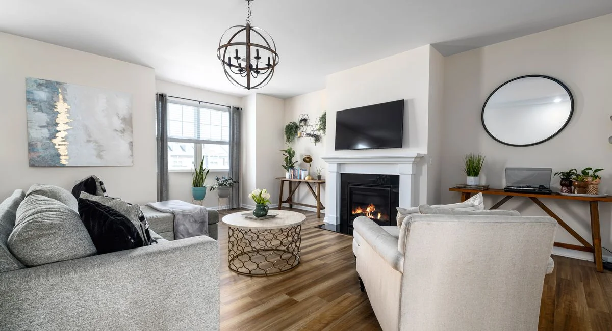 A stylish and cozy living room featuring a fireplace, modern furniture, and elegant decor.