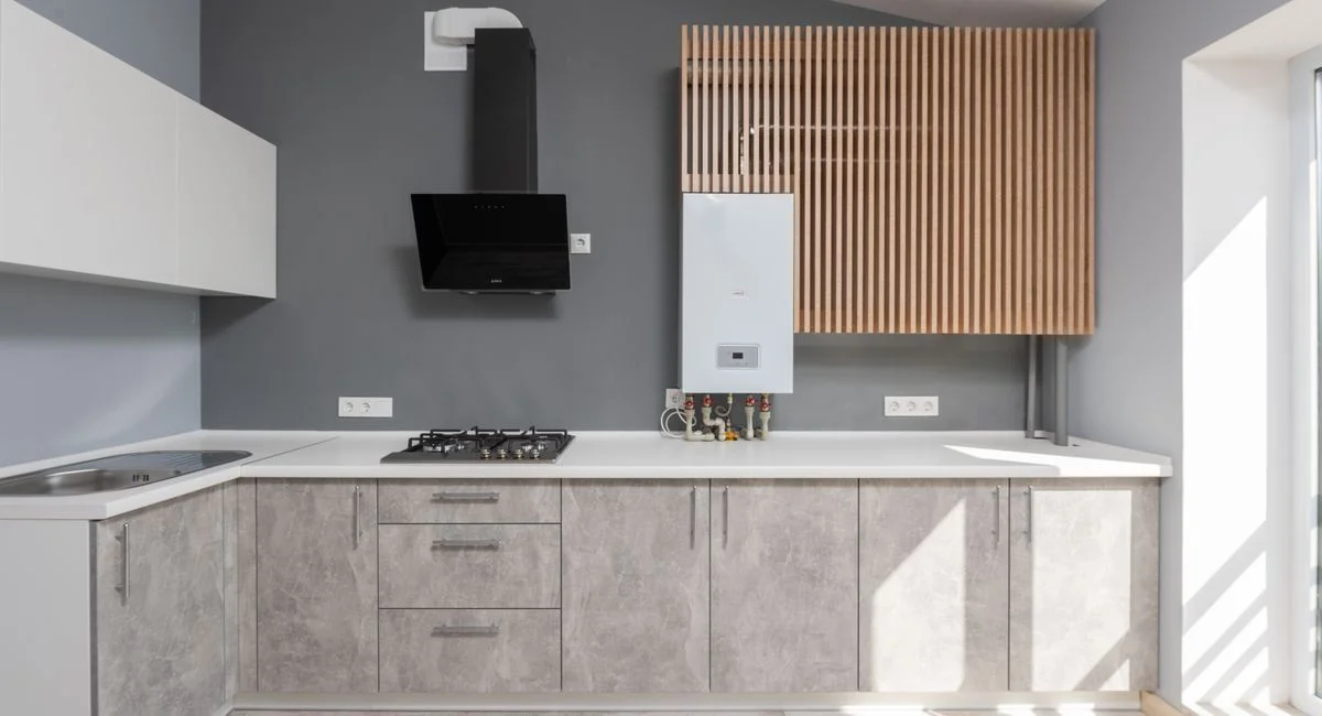 Bright modern kitchen interior design with appliances and cabinetry.