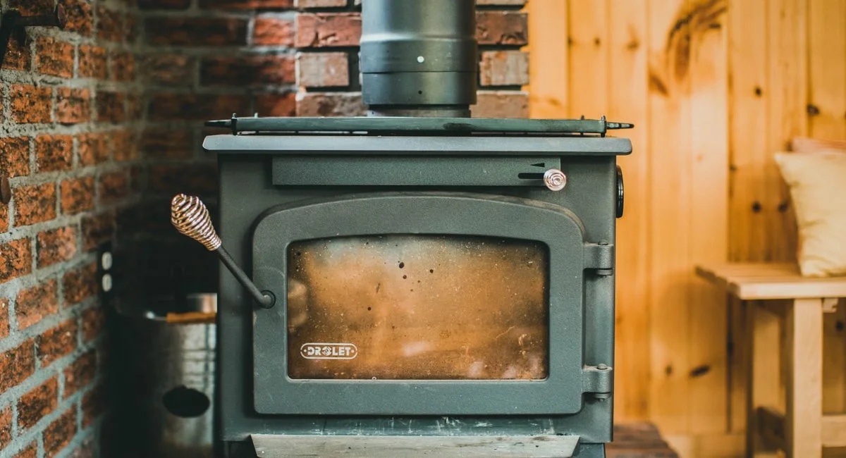 Warm indoor scene with a classic wood stove in a rustic cabin setting, ideal for cozy retreats.