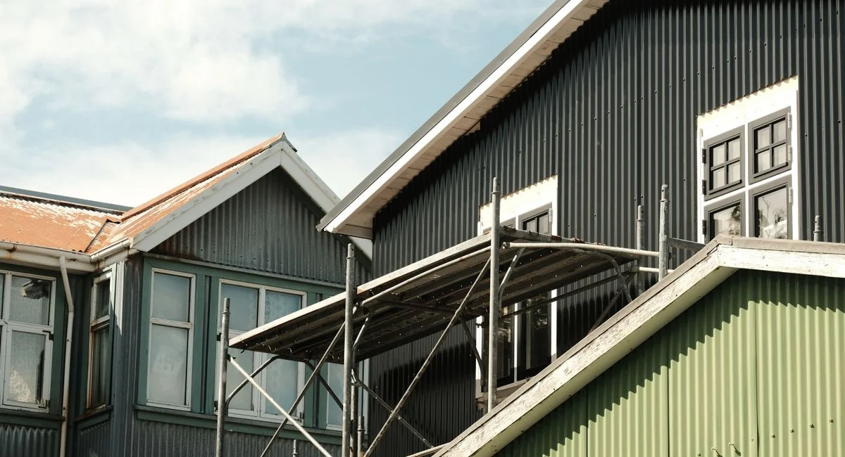 Scandinavian architecture in Reykjavík with colorful corrugated metal siding, captured in bright daylight.