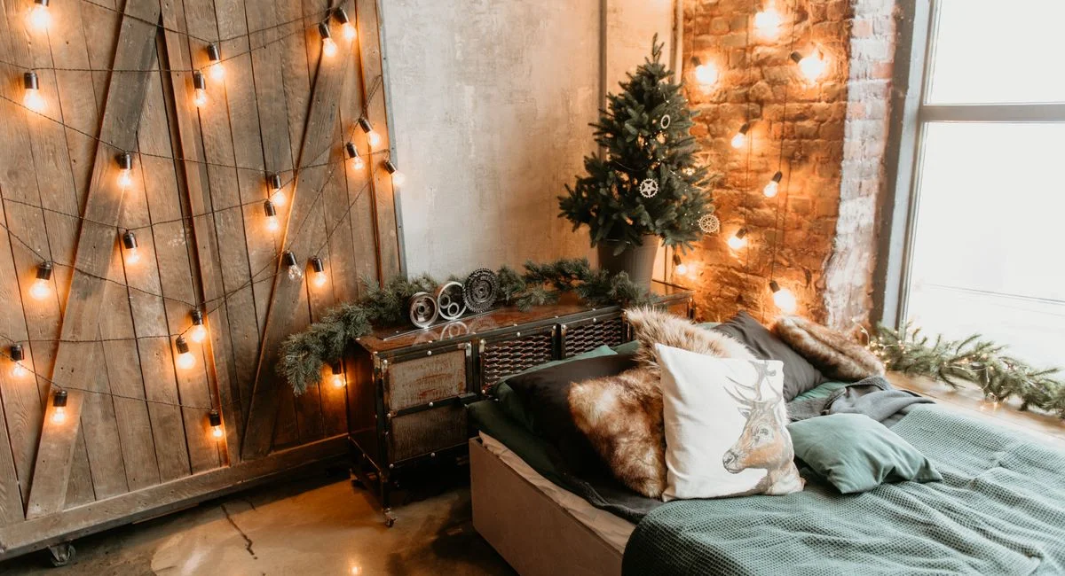 Warm, festive bedroom with Christmas lights and rustic decor, perfect for holiday inspiration.